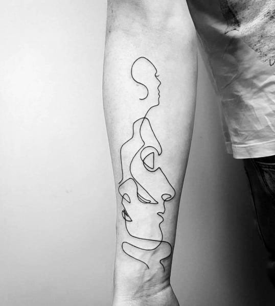 Abstract continuous line tattoo on the forearm, depicting multiple interconnected faces in a minimalist black ink design for a modern artistic look.