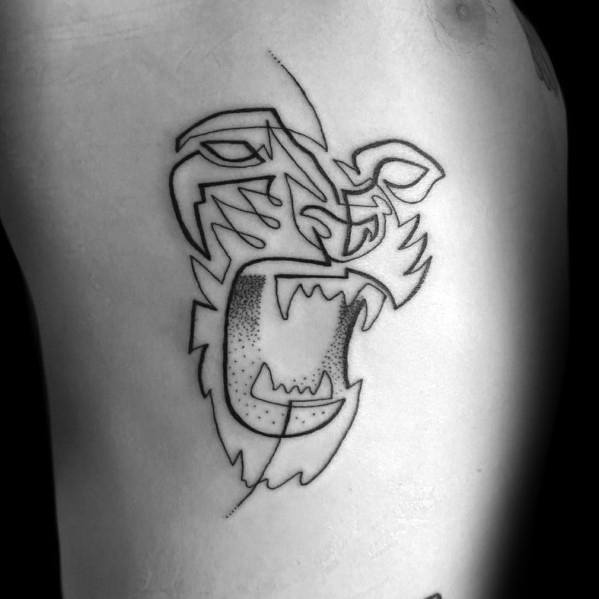 Geometric continuous line tattoo of a roaring tiger on the ribcage, featuring bold black ink with sharp angles and subtle dot shading.
