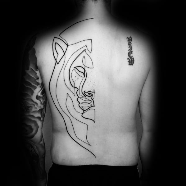 Abstract continuous line tattoo of a stylized face on the back, featuring bold black ink strokes with geometric and artistic elements.