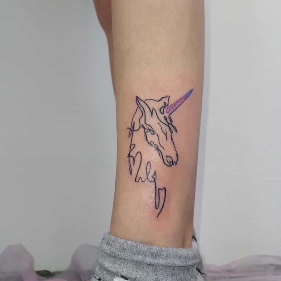 Minimalist unicorn tattoo on the ankle, created with a continuous line art design and a subtle purple gradient on the horn.