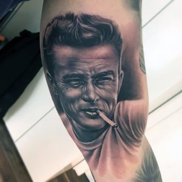 Realistic tattoo of James Dean with a cigarette in his mouth, styled in a classic white tee and slicked-back hair.