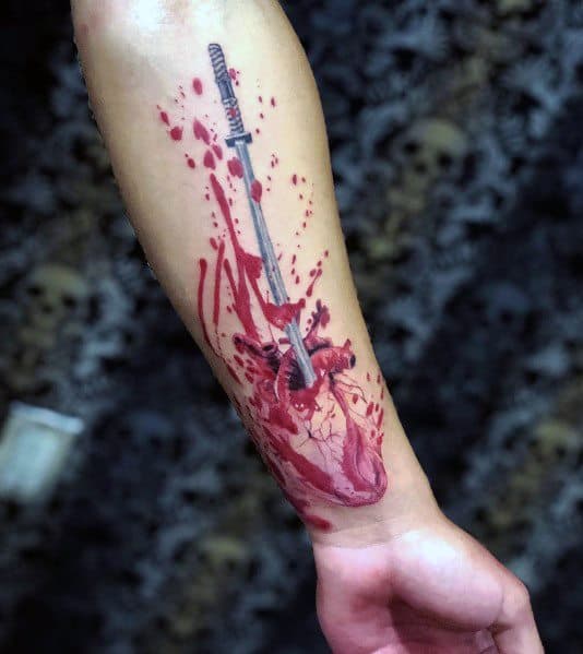 Realistic 3D tattoo of an anatomical heart pierced by a sword, with splattered blood effects, creating a bold and dramatic forearm design.