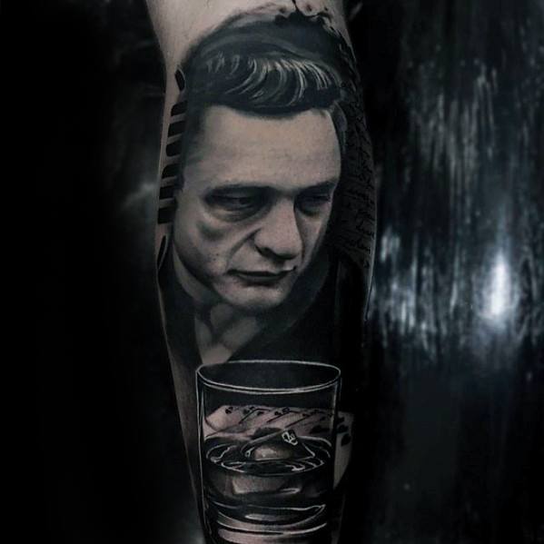 Tattoo of a serious Johnny Cash with a drink