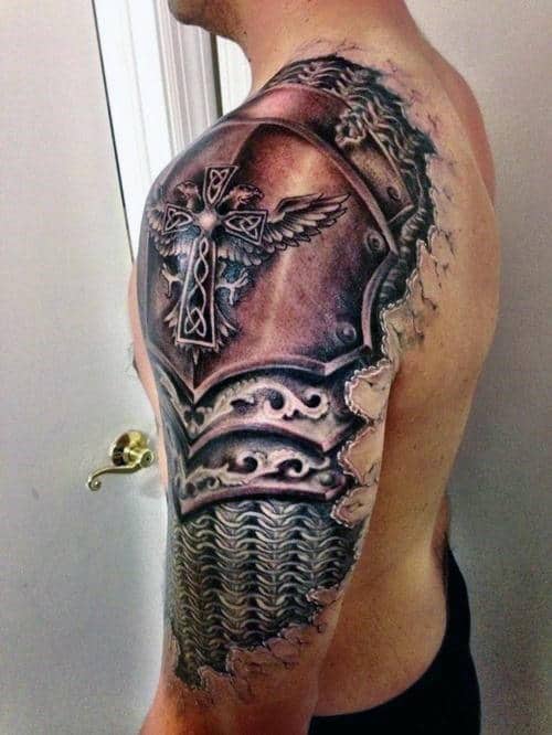 Man with an intricate armor tattoo covering his shoulder, upper arm, and part of his chest