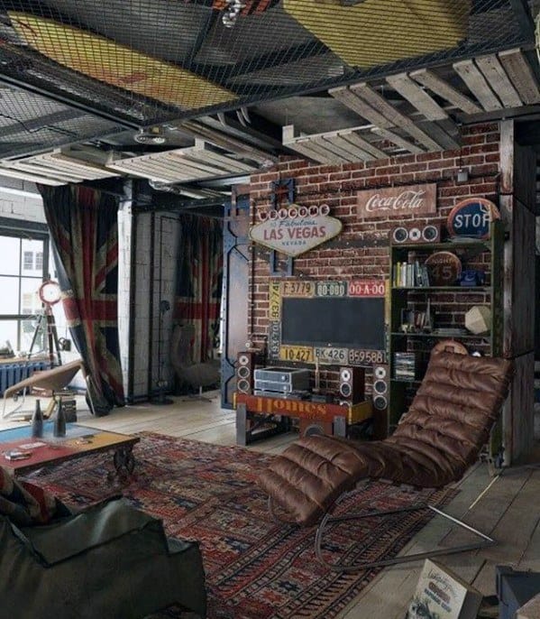 Eclectic living room with vintage decor, metal ceiling, leather chaise, and rug on wooden floor