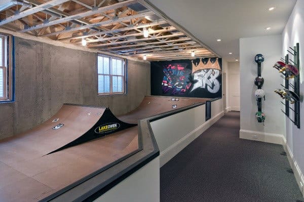 basement skating ramp exposed ceiling skateboard rack 