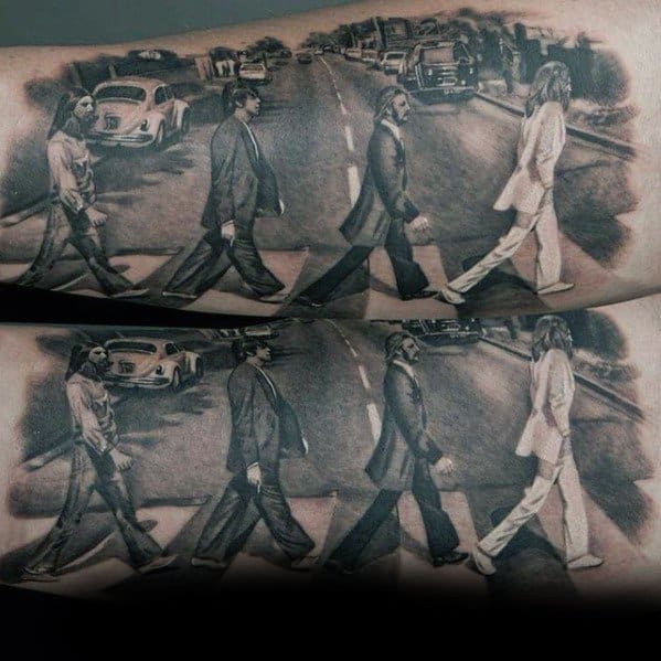 Hyper-realistic black and gray tattoo of The Beatles’ Abbey Road crossing scene, duplicated across both forearms to form a complete panorama.