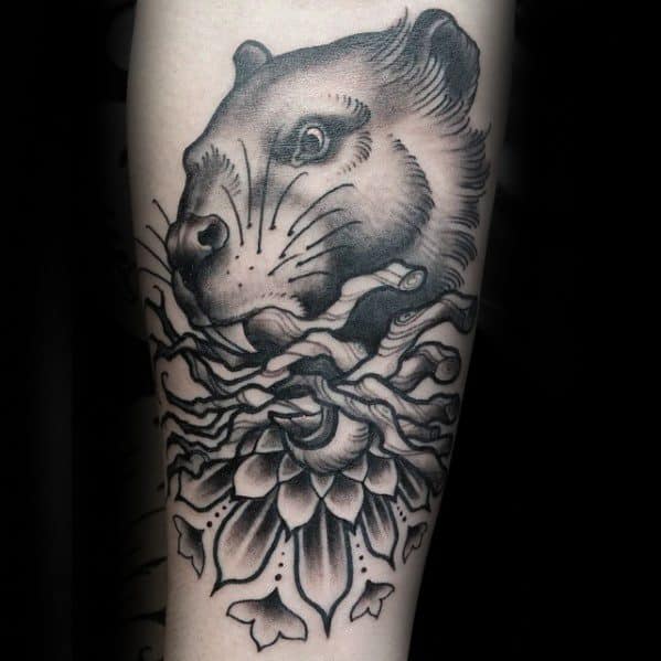 Black and grey beaver tattoo with a serene face emerging from swirling water and a lotus flower, blending realism and elegance.