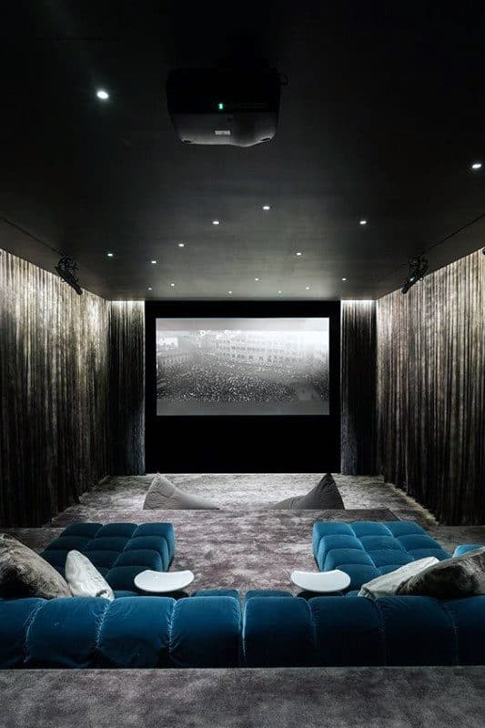 cool black ceiling movie room basement blue sofa 