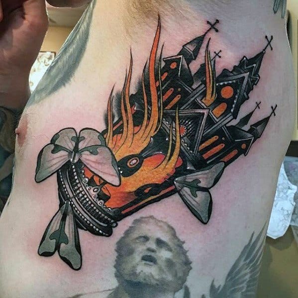 Burning church tattoo styled as a missile crashing down, wrapped in flames. Features gothic windows, crosses, and decorative ribbons.