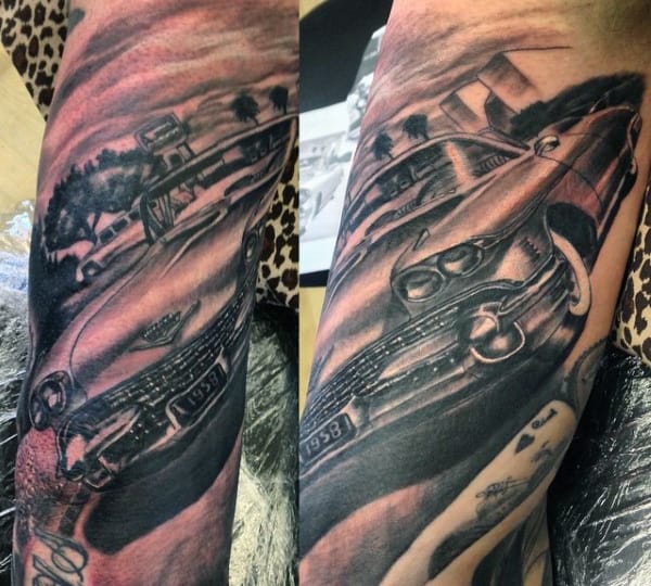 Tattoo of a vintage car and a street scene spanning across a forearm with detailed shading and perspective