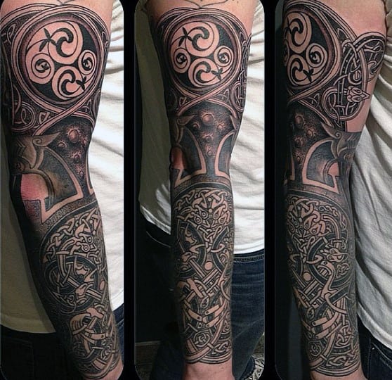 Detailed geometric and Celtic-themed full sleeve tattoo on an arm