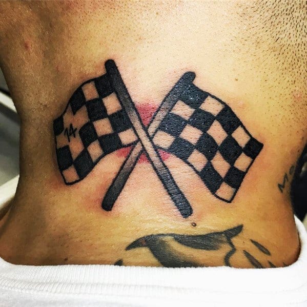 Bold crossed checkered flags tattoo on the upper back, symbolizing racing victory, speed, and a passion for motorsports.