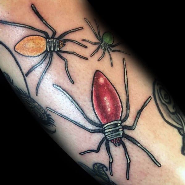 Christmas tattoo of spiders with holiday light bulbs for bodies, blending a spooky and festive theme with bold colors and fine detailing.