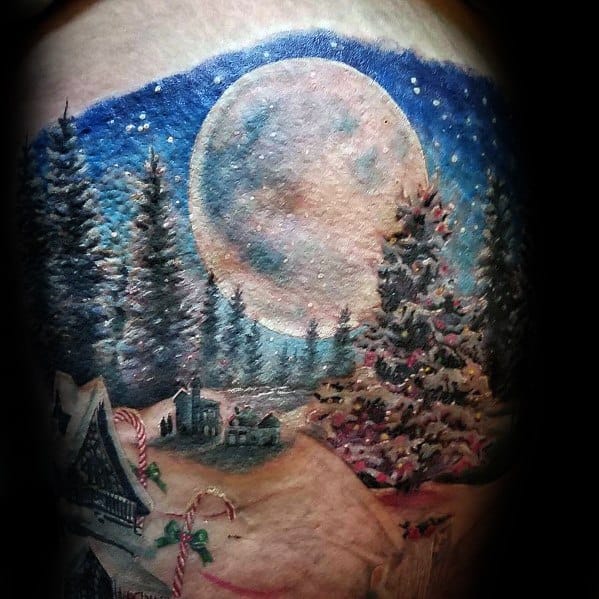 Realistic Christmas night tattoo featuring a glowing full moon, decorated tree, snowy village, and candy canes, creating a festive winter scene.