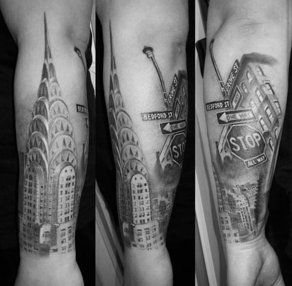 Black-and-grey Chrysler Building tattoo with NYC street signs and a stop sign, creating an urban cityscape with depth and realism.