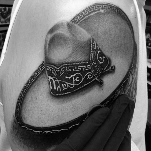 Tattoo of a highly detailed sombrero with intricate patterns, shaded in black and gray for a realistic 3D effect.