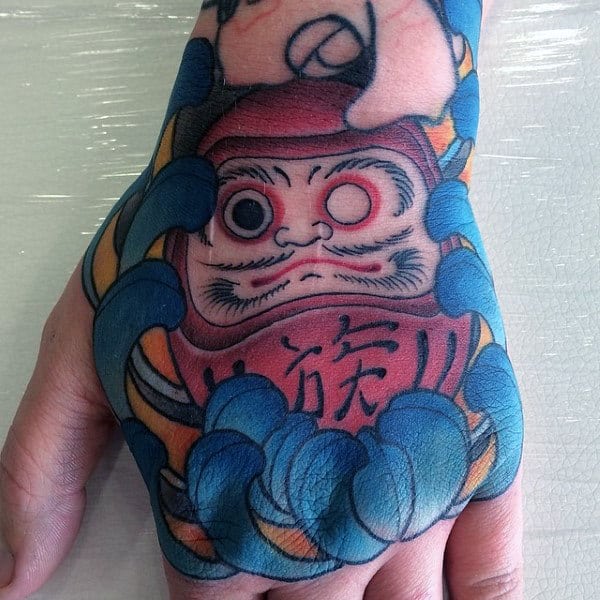 Cool Daruma Doll With Blue Flower Mens Hand Tattoos