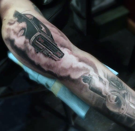 Black and grey Dodge Charger tattoo with smoke effect and a gear shift, creating a bold and dynamic automotive sleeve design.