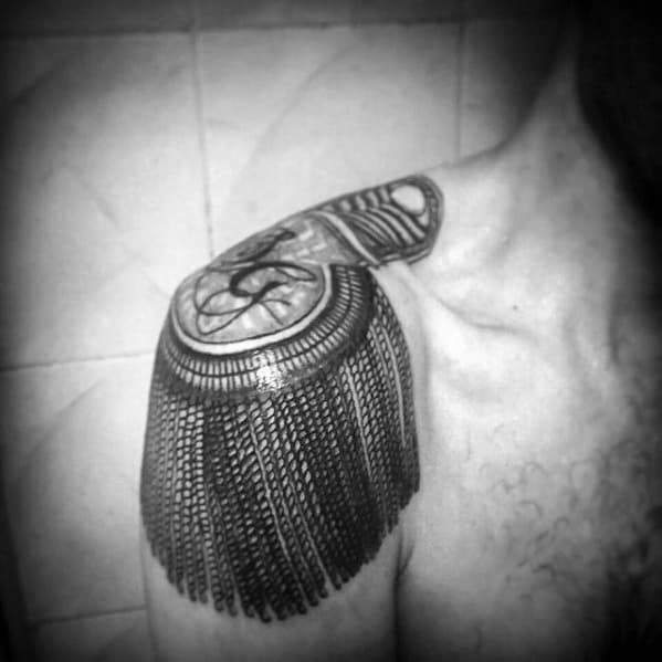 Realistic epaulette tattoo on shoulder with intricate rope patterns, a bold insignia, and cascading ornamental tassels.