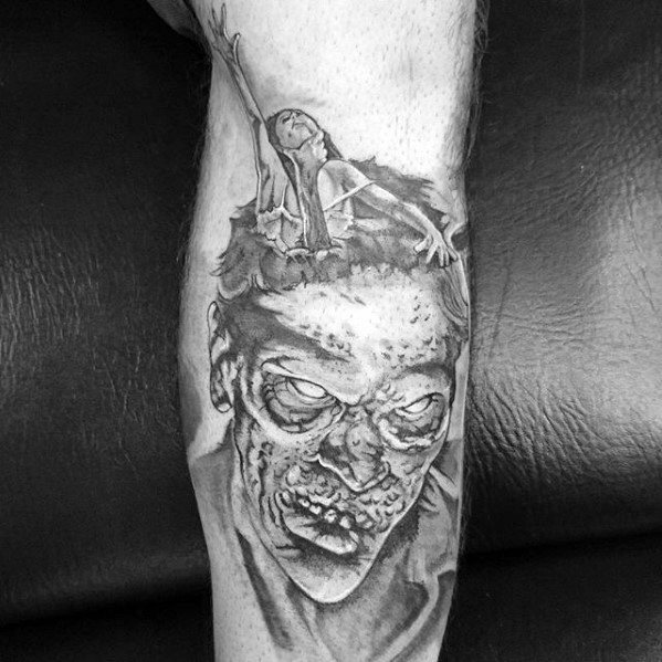 Black and grey Evil Dead tattoo of a decaying demon face with a screaming woman being pulled from its head, capturing horror and despair.