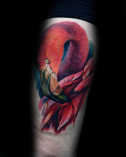 Hyper-realistic flamingo tattoo with rich red and pink tones, detailed feathers, and lifelike shading, creating a bold and elegant design.