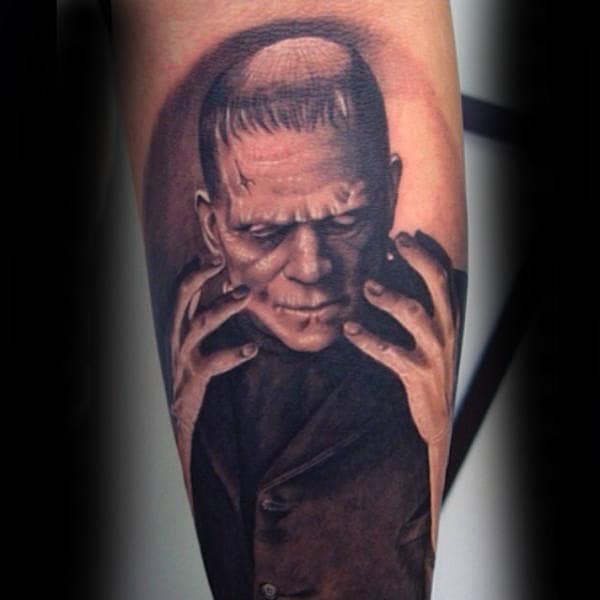 Cool Frankenstein Looking At Hands Tattoo For Guys On Leg