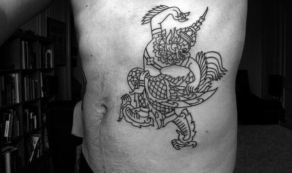 Minimal Garuda tattoo on the side torso in fine black linework, featuring a dynamic pose with traditional headgear and mythological details.