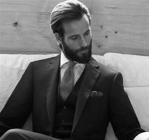 Man with slicked-back hair and a full beard