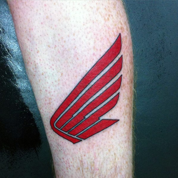 Red Honda Wing logo tattoo on a man's forearm, featuring bold lines and a sleek, minimalist design.