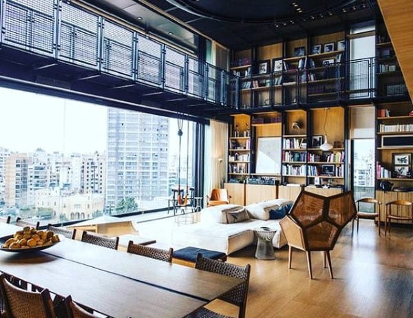 Spacious living room with floor-to-ceiling windows, modern furniture, and city view.