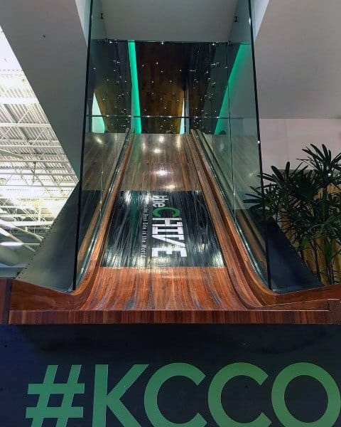 Slide down the tall indoor slide with wooden sides and green lighting, labeled "the CHIVE