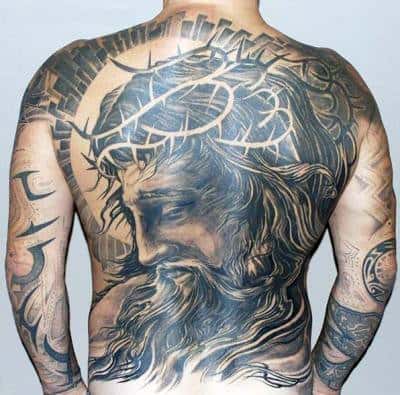 Back tattoo of Jesus with a crown of thorns, dramatic shading and intricate details