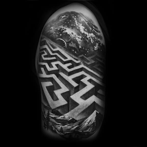 Realistic black and grey labyrinth tattoo on a man's arm, featuring a 3D maze leading to a cosmic landscape with mountains and a swirling sky.