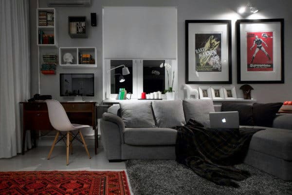 Modern living room with grey sofa, home office desk, and stylish wall art decor.
