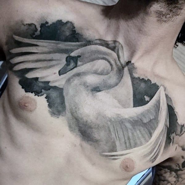 Large swan tattoo across the chest with wings extended and set against dark cloud shading, symbolizing strength and elegance.
