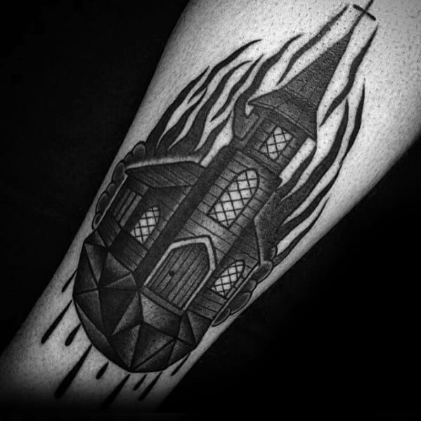 Blackwork burning church tattoo with bold shading and flame outlines. The church sits on a geometric floating rock with dripping details.