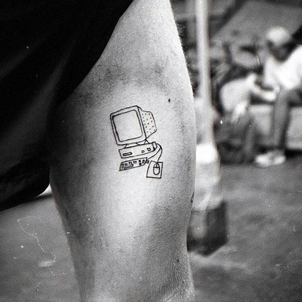 Minimalist black line tattoo of a vintage desktop computer setup with keyboard, floppy disk, and mouse on the upper leg.