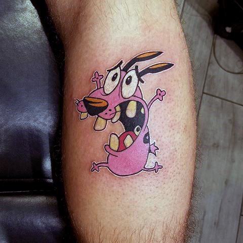 Tattoo of Courage the Cowardly Dog in a panicked pose, with wide eyes and mouth open, placed on the side of the calf.