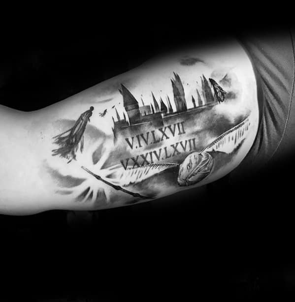 Harry Potter tattoo featuring a Dementor, Hogwarts silhouette, Roman numerals, and a flying snitch on the upper arm.