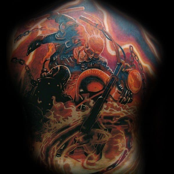 Ghost Rider tattoo showing a fiery skull riding a flaming motorcycle with chains and smoke swirling in a high-energy action scene.