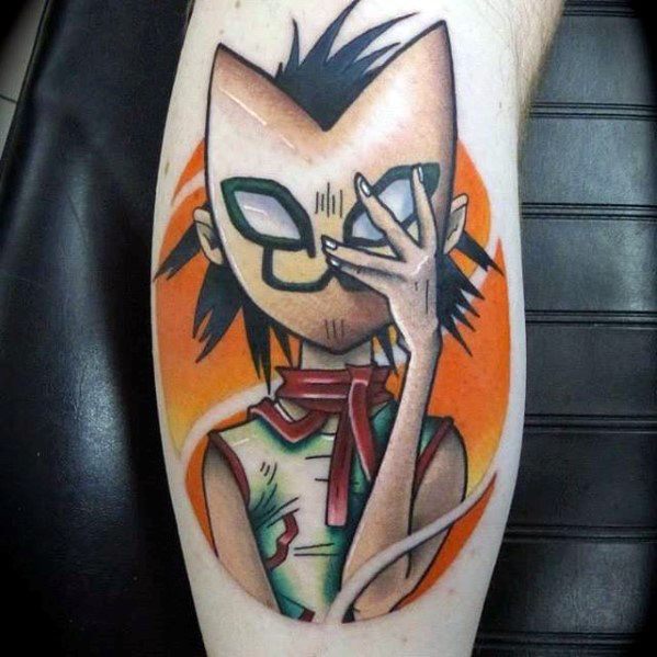 Colorful tattoo of Noodle from Gorillaz holding a fox mask over her face, set against a bold orange background with sharp detailing.