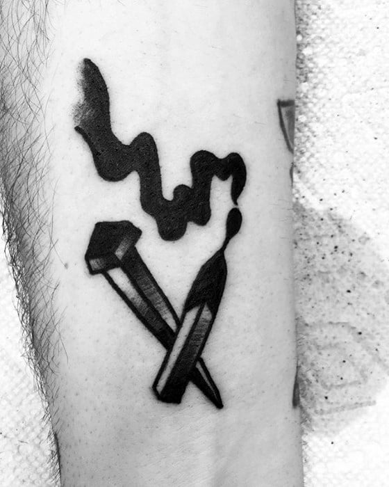 Bold black ink tattoo of two burnt matches with rising smoke, symbolizing intensity, passion, or something that’s come to an end.