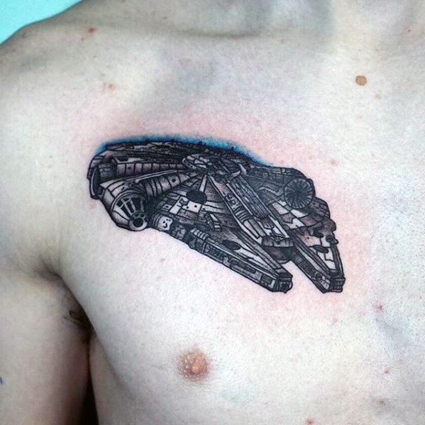 Highly detailed Millennium Falcon chest tattoo in black and grey with a touch of blue shading behind the ship.