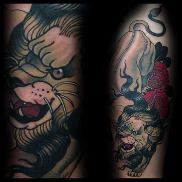 Neo-traditional lion tattoo with fierce expression, dark mane, and red flower details, wrapping boldly around the forearm.