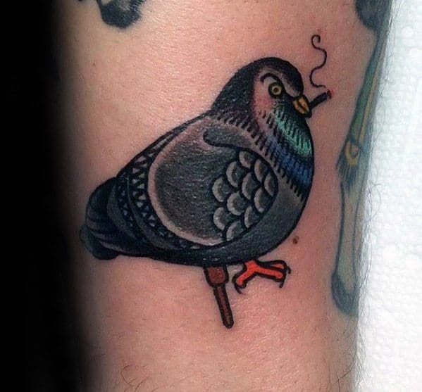 Playful pigeon tattoo with bold outlines, perched and smoking a cigarette, featuring subtle color accents and a humorous twist.