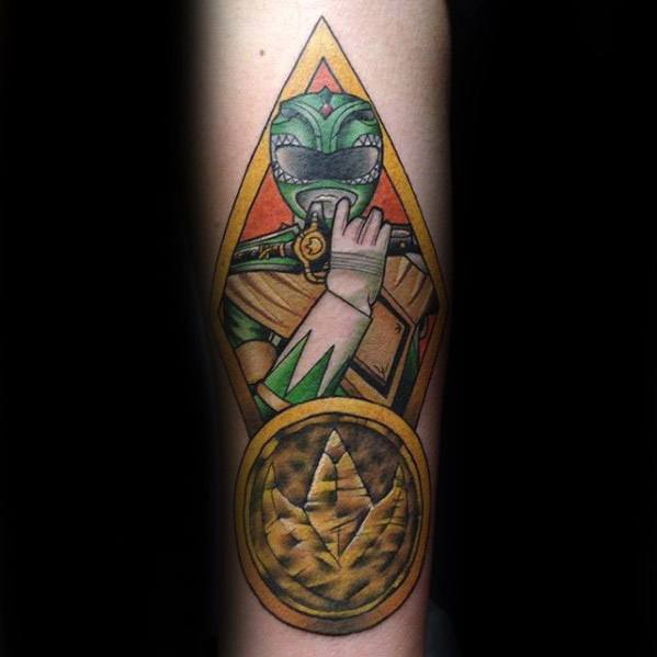 Detailed Green Ranger tattoo holding the Dragon Dagger, framed in a golden triangle with a bold Power Coin at the bottom.
