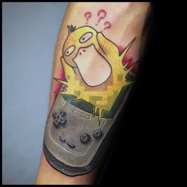 Creative Psyduck tattoo showing it bursting from a Game Boy with pixelated effects and question marks, inked on a man's forearm.