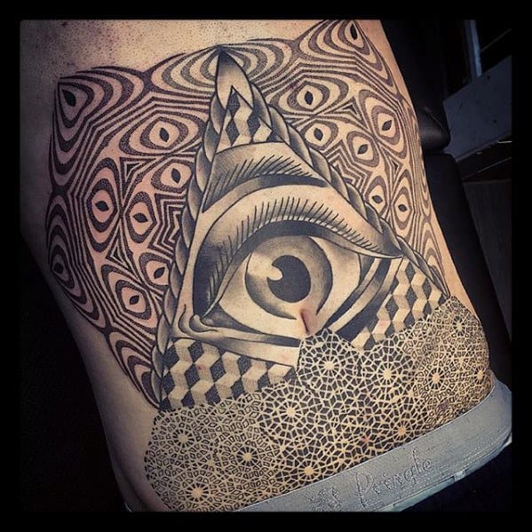 Large back tattoo featuring an all-seeing eye within a triangle, surrounded by hypnotic patterns and intricate geometric dotwork.