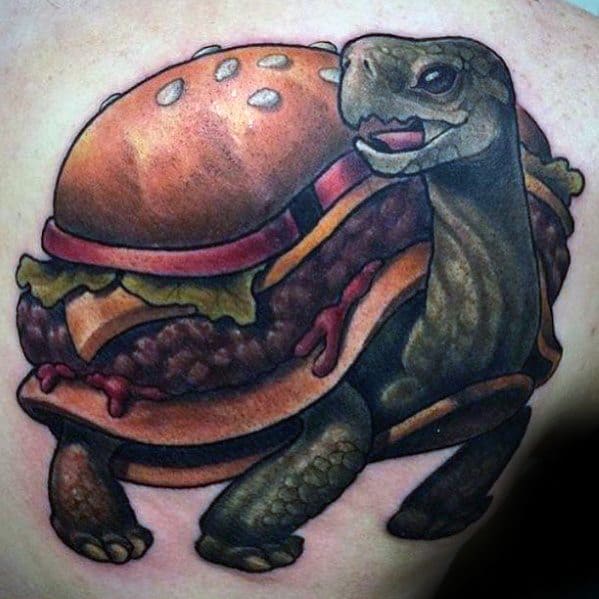 Tattoo of a turtle with a cheeseburger shell, featuring lettuce, cheese, and tomato